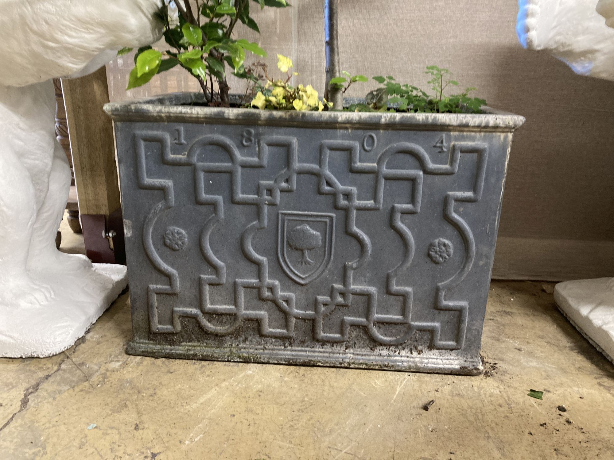 A rectangular faux lead garden planter, width 66cm, depth 46cm, height, 46cm with large bay tree(?)